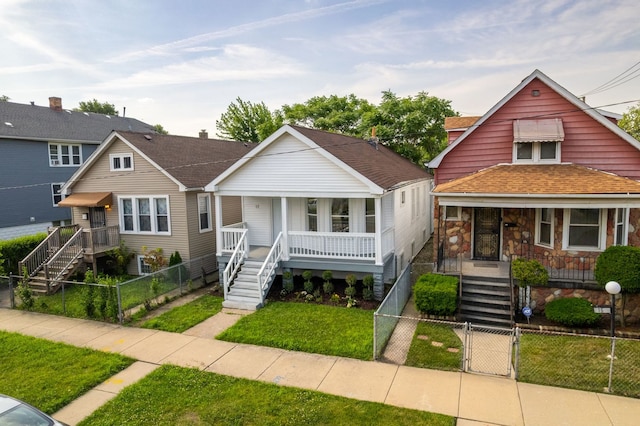17 E 100th Pl, Chicago, IL 60628 - bungalow-style home with covered porch, a gate, stairs, and a fenced front yard