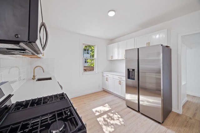 17 E 100th Pl, Chicago, IL 60628 - kitchen featuring appliances with stainless steel finishes, light wood-style floors, tasteful backsplash, and light countertops