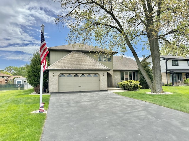 view of front of home with asphalt driveway, an attached garage, a shingled roof, and brick siding