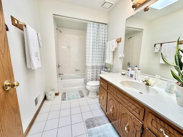 full bathroom featuring tile patterned flooring, vanity, toilet, shower / tub combo, and a skylight