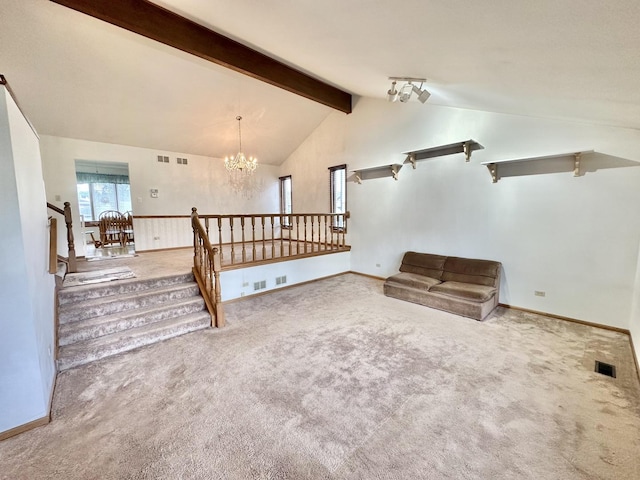 carpeted empty room with a chandelier and baseboards