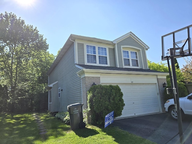 569 Arbor Ln, South Elgin, IL 60177 - view of home's exterior with asphalt driveway, an attached garage, brick siding, and a yard