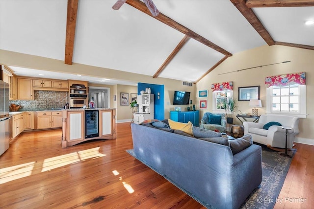 3N369 Lafox Rd, Saint Charles, IL 60175 - living room featuring wine cooler, beam ceiling, light wood-type flooring, baseboards, and high vaulted ceiling