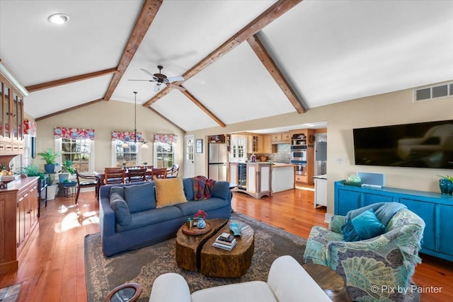 3N369 Lafox Rd, Saint Charles, IL 60175 - living area featuring ceiling fan, light wood-style floors, beam ceiling, beverage cooler, and high vaulted ceiling