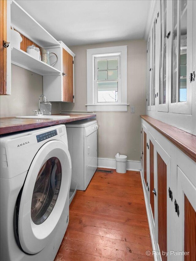 3N369 Lafox Rd, Saint Charles, IL 60175 - washroom featuring cabinet space, light wood-style floors, washing machine and clothes dryer, and baseboards