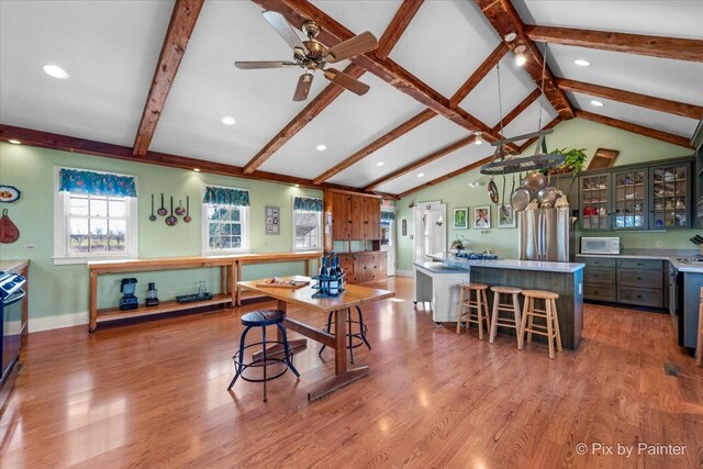 3N369 Lafox Rd, Saint Charles, IL 60175 - kitchen with freestanding refrigerator, white microwave, a kitchen island, glass insert cabinets, and wood finished floors