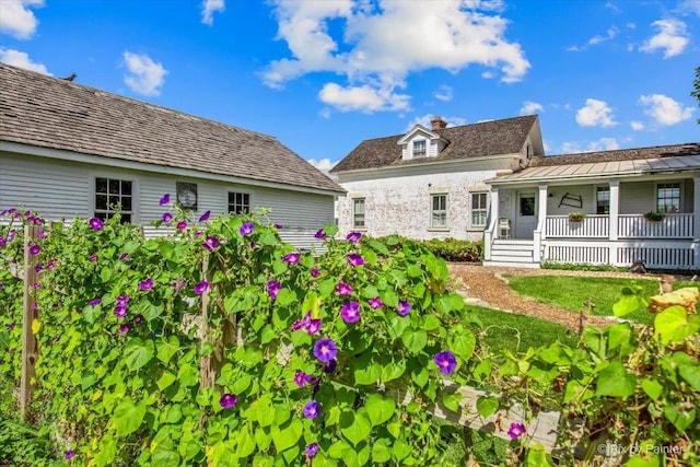 3N369 Lafox Rd, Saint Charles, IL 60175 - back of property featuring covered porch, a chimney, and stone siding