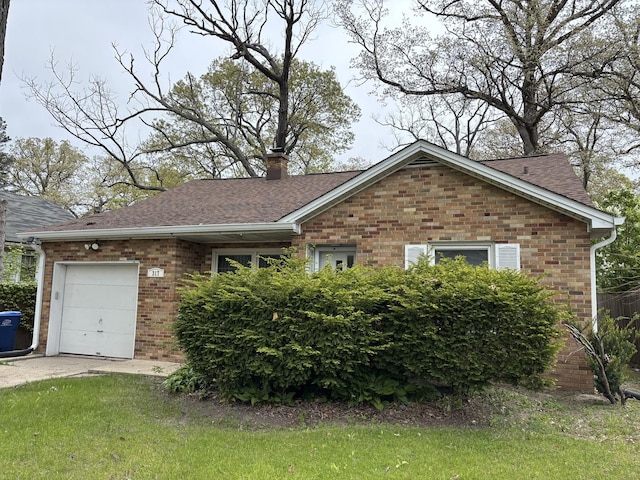 317 N Jackson St, Waukegan, IL 60085 - view of front of property with brick siding, a garage, a chimney, concrete driveway, and roof with shingles