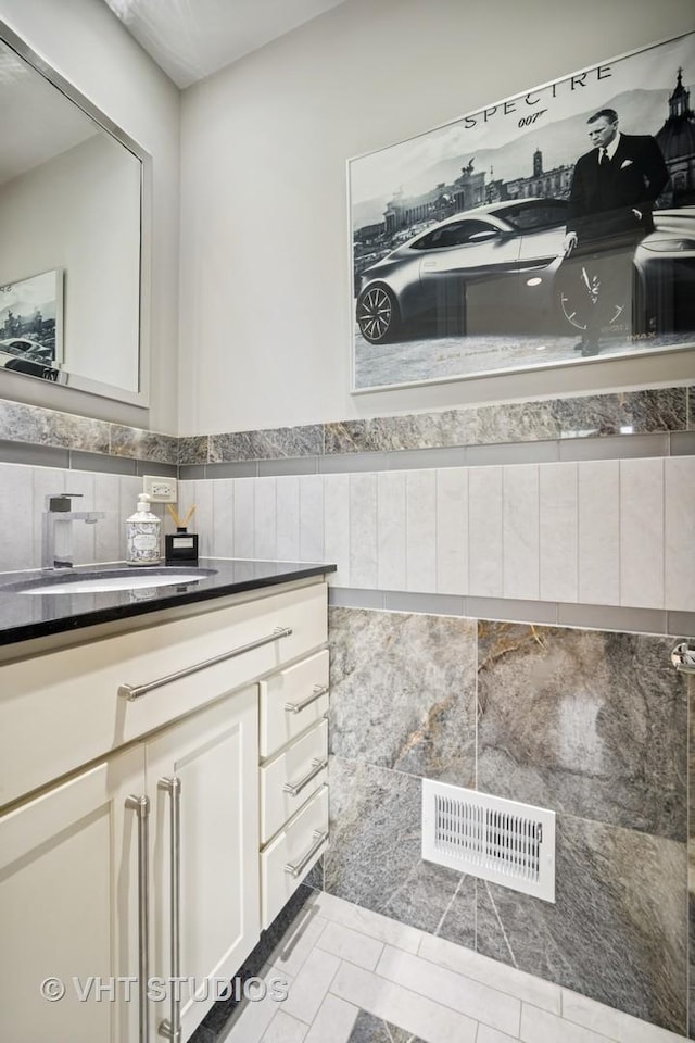 5654 N Manor Ln, Norwood Park, IL 60631 - bathroom with vanity, tile walls, and tile patterned floors