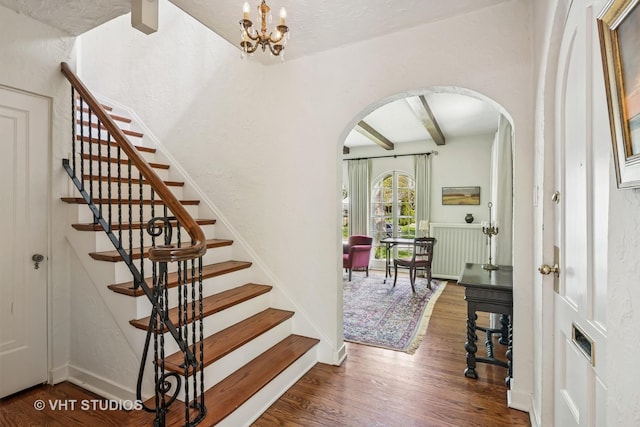 2037 Highland Ave, Wilmette, IL 60091 - stairs featuring arched walkways, wood finished floors, beamed ceiling, and a chandelier