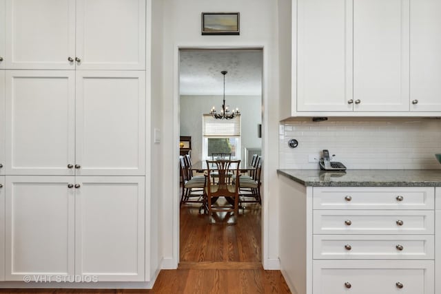 2037 Highland Ave, Wilmette, IL 60091 - kitchen with decorative backsplash, wood finished floors, and white cabinets