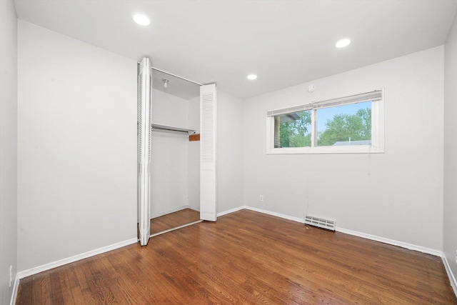 15245 Millard Ave, Midlothian, IL 60445 - unfurnished bedroom featuring baseboards, wood finished floors, a closet, and recessed lighting