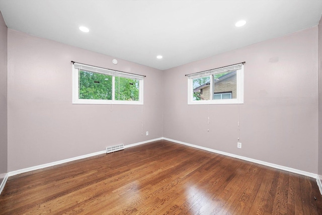 15245 Millard Ave, Midlothian, IL 60445 - empty room featuring plenty of natural light, baseboards, wood finished floors, and recessed lighting