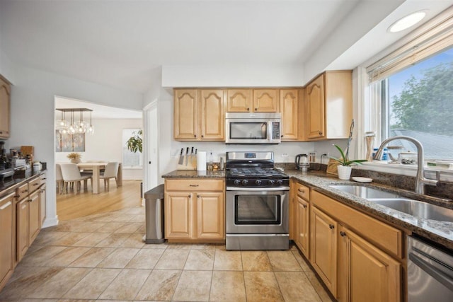 9013 Charing Cross Rd, Woodridge, IL 60517 - kitchen featuring stainless steel appliances, a sink, dark stone counters, and a chandelier