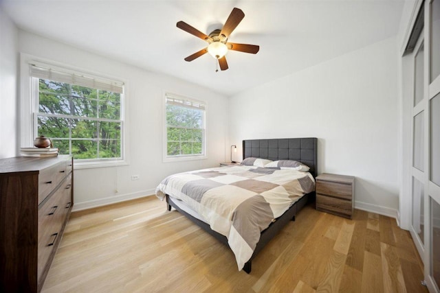9013 Charing Cross Rd, Woodridge, IL 60517 - bedroom with light wood-type flooring, baseboards, and a ceiling fan