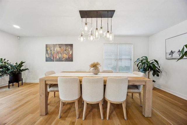 9013 Charing Cross Rd, Woodridge, IL 60517 - dining room featuring light wood-style floors, a chandelier, and baseboards
