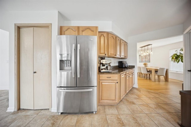 9013 Charing Cross Rd, Woodridge, IL 60517 - kitchen with stainless steel refrigerator with ice dispenser, a chandelier, dark stone counters, and baseboards
