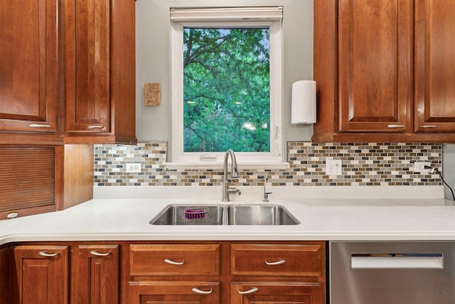 915 Eaton Ct, Lake Villa, IL 60046 - kitchen with stainless steel dishwasher, a sink, light countertops, and decorative backsplash