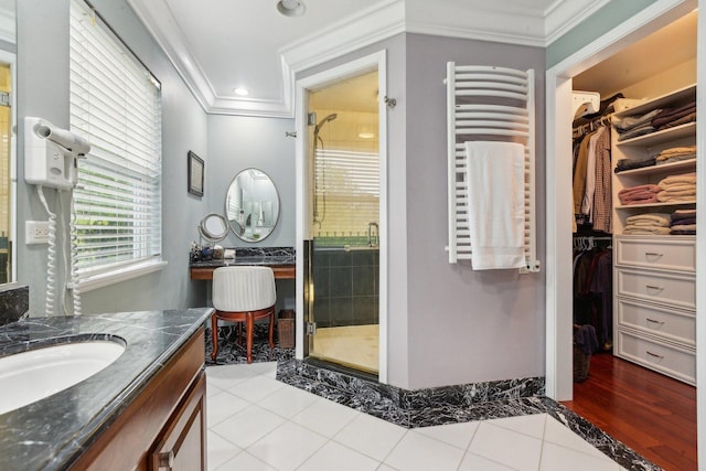 915 Eaton Ct, Lake Villa, IL 60046 - full bathroom featuring radiator heating unit, vanity, crown molding, a stall shower, and a walk in closet