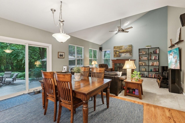 915 Eaton Ct, Lake Villa, IL 60046 - dining area featuring ceiling fan, wood finished floors, lofted ceiling, and a premium fireplace