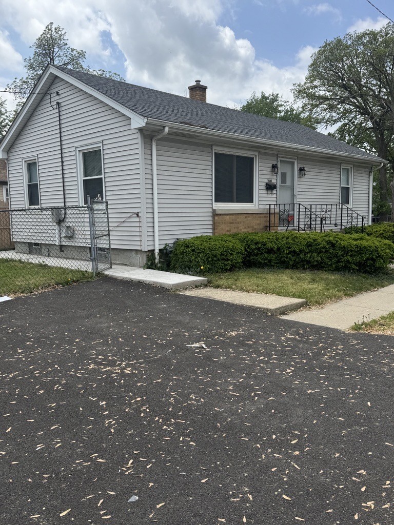 1600 Elgin Ave, Joliet, IL 60432 - ranch-style house with a chimney and roof with shingles