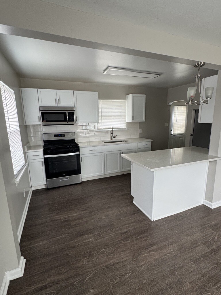 1600 Elgin Ave, Joliet, IL 60432 - kitchen with appliances with stainless steel finishes, a sink, white cabinets, and decorative backsplash