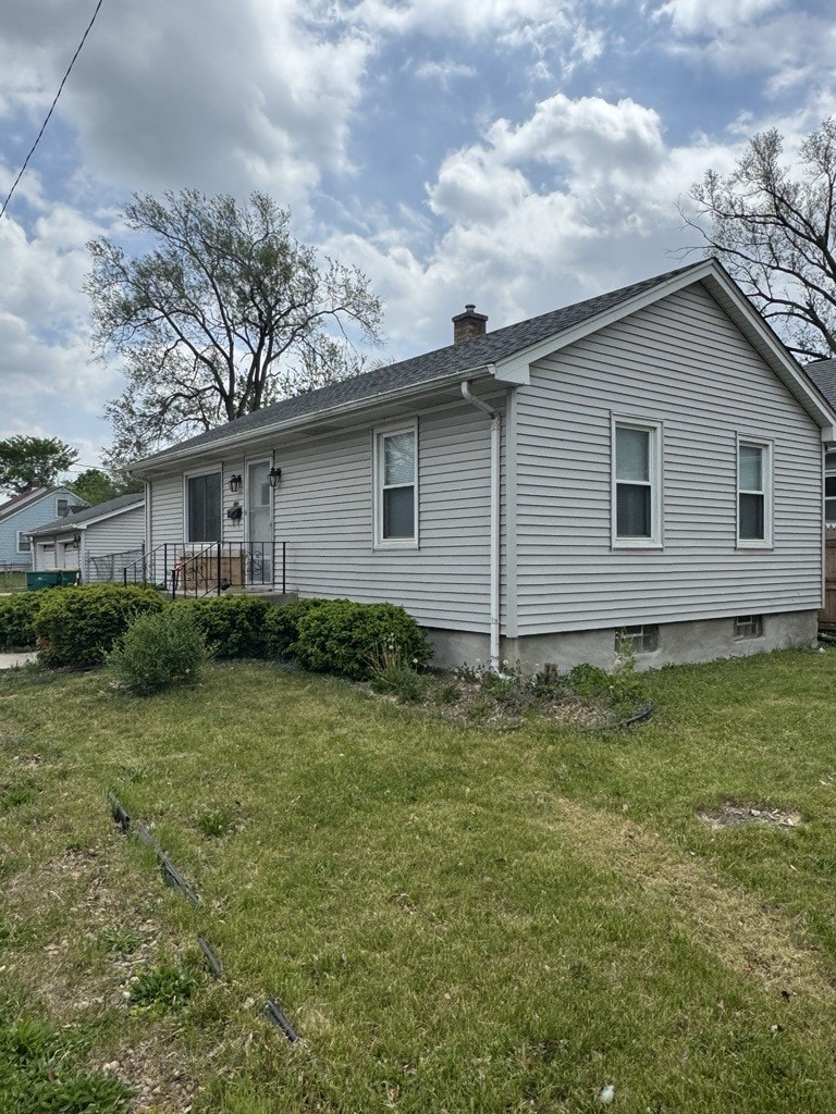 1600 Elgin Ave, Joliet, IL 60432 - rear view of house featuring a chimney and a yard