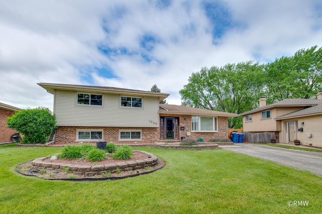1236 N Fischer Dr, Addison, IL 60101 - split level home featuring brick siding, a front yard, and asphalt driveway