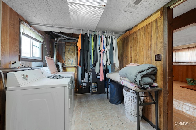 1236 N Fischer Dr, Addison, IL 60101 - laundry area with light tile patterned flooring, wooden walls, healthy amount of natural light, and separate washer and dryer