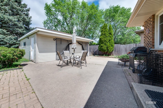1236 N Fischer Dr, Addison, IL 60101 - view of patio with fence, outdoor dining area, an outbuilding, grilling area, and a detached garage