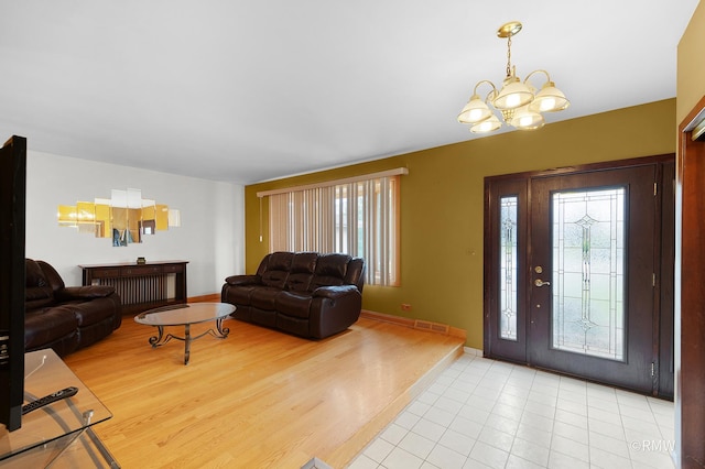 1236 N Fischer Dr, Addison, IL 60101 - foyer with a chandelier, light wood-type flooring, and baseboards