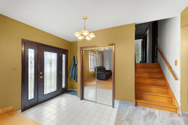 1236 N Fischer Dr, Addison, IL 60101 - foyer entrance with stairway, a chandelier, light tile patterned floors, and baseboards