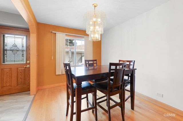 1236 N Fischer Dr, Addison, IL 60101 - dining area featuring a chandelier, light wood-style flooring, and baseboards