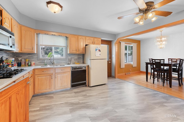1236 N Fischer Dr, Addison, IL 60101 - kitchen featuring a sink, black appliances, light countertops, backsplash, and a ceiling fan