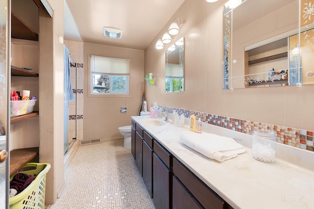 1236 N Fischer Dr, Addison, IL 60101 - full bathroom with a shower stall, toilet, vanity, decorative backsplash, and tile patterned floors