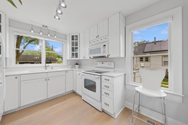 340 S Grant St, Westmont, IL 60559 - kitchen with white appliances, a sink, white cabinets, and plenty of natural light