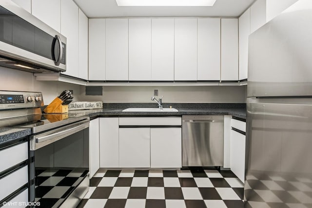 900 N Lake Shore Dr Unit 2906, Chicago, IL 60611 - kitchen featuring stainless steel appliances, a sink, dark flooring, and white cabinets