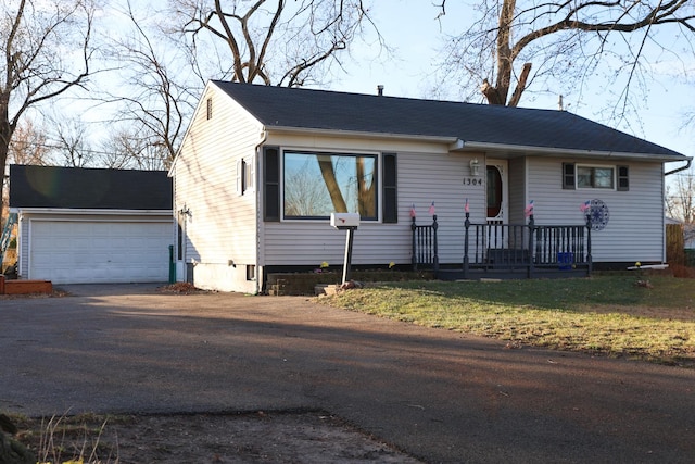 view of front of house with asphalt driveway and a garage