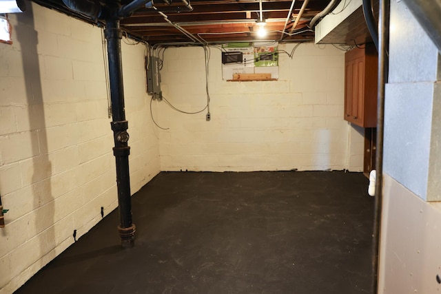 unfinished below grade area with electric panel and heating unit