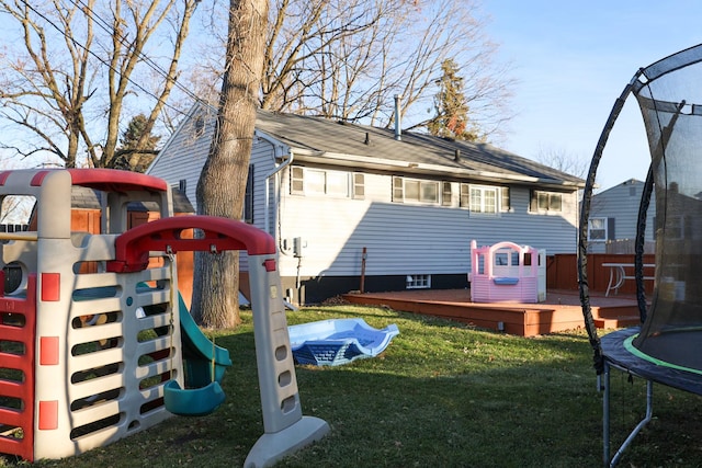 view of play area featuring a trampoline and a deck