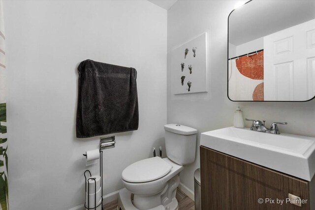 1565 Cornell Pl, Hoffman Estates, IL 60169 - full bath with toilet, vanity, baseboards, and wood finished floors
