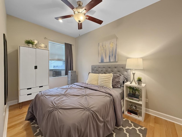 1325 W Addison St Unit 1A, Chicago, IL 60613 - bedroom with radiator heating unit, baseboards, light wood finished floors, and ceiling fan