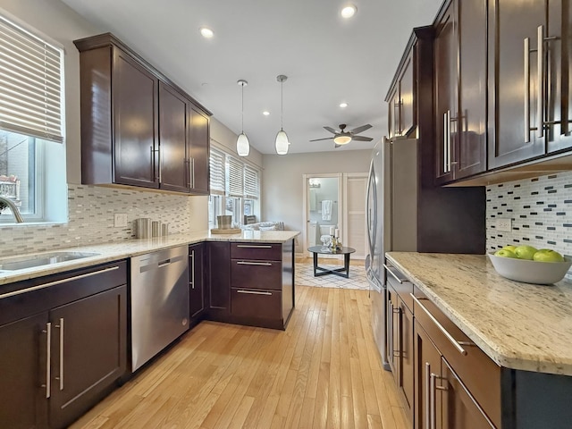 1325 W Addison St Unit 1A, Chicago, IL 60613 - kitchen with dishwasher, a sink, ceiling fan, a peninsula, and dark brown cabinets