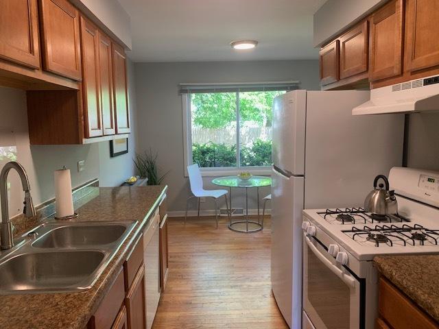 810 Skokie Blvd Unit C, Wilmette, IL 60091 - kitchen with white appliances, a sink, under cabinet range hood, and brown cabinets