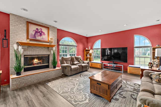 5008 Country Springs Dr, Johnsburg, IL 60051 - living room featuring wood finished floors, healthy amount of natural light, a brick fireplace, and recessed lighting