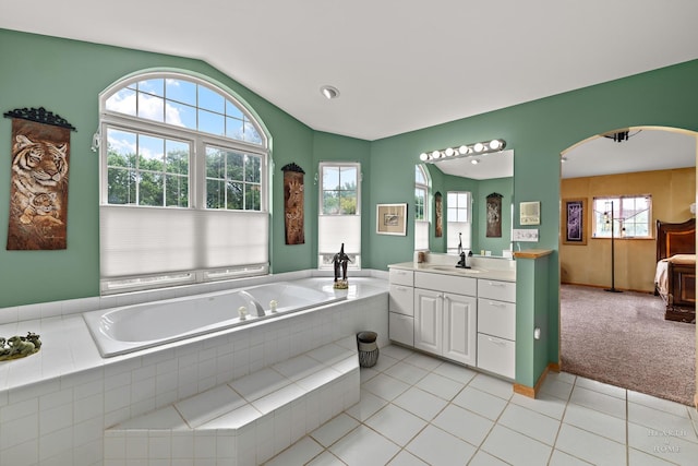 5008 Country Springs Dr, Johnsburg, IL 60051 - bathroom featuring lofted ceiling, vanity, a bath, ensuite bathroom, and tile patterned flooring