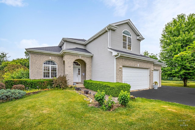 5008 Country Springs Dr, Johnsburg, IL 60051 - traditional-style house featuring brick siding, an attached garage, asphalt driveway, and a front lawn