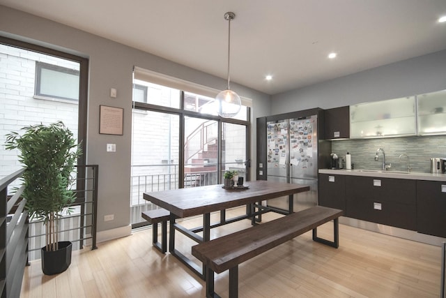 1529 W Chestnut St Unit 102, Chicago, IL 60642 - dining space featuring light wood-style floors, bar with sink, and recessed lighting