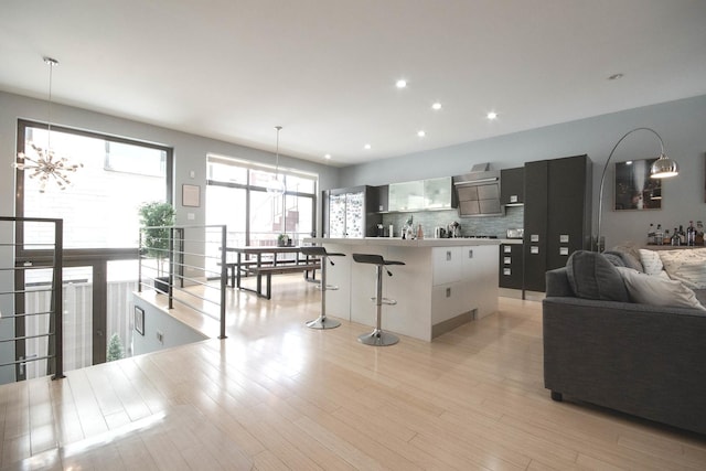 1529 W Chestnut St Unit 102, Chicago, IL 60642 - kitchen with a chandelier, tasteful backsplash, a kitchen bar, open floor plan, and a kitchen island