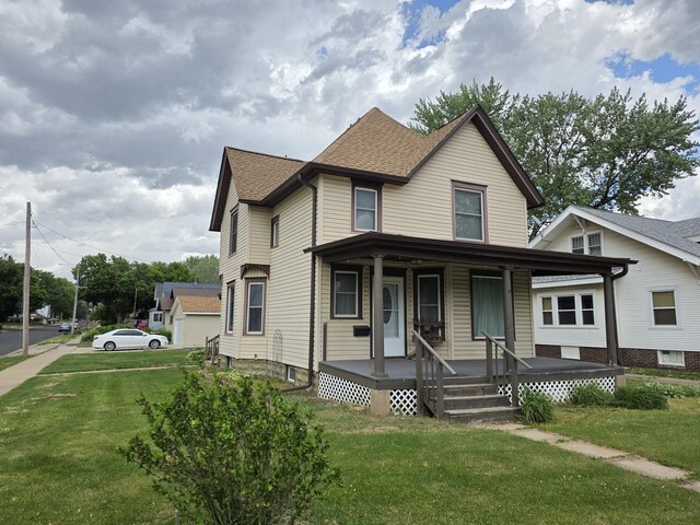 401 Dixon Ave, Rock Falls, IL 61071 - victorian house featuring a porch, a front lawn, and roof with shingles